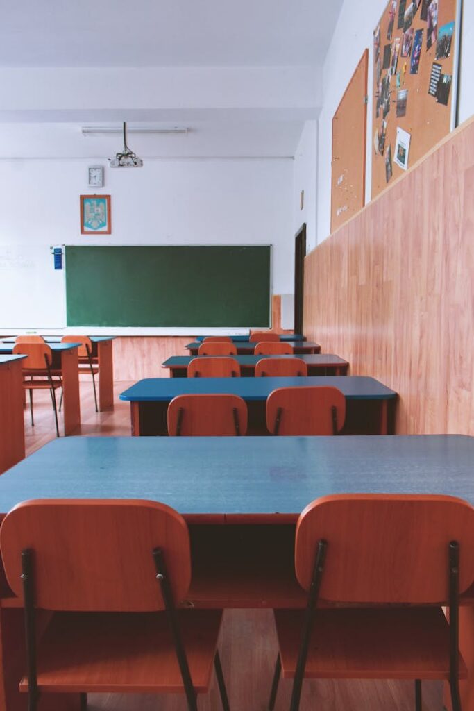 pexels photo 2675061 A tranquil empty classroom with wooden furniture and a green chalkboard, perfect for educational themes.